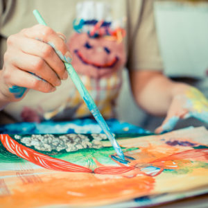 particular of woman painter hand painting in her studio